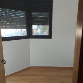 Bedroom with two black aluminium windows and new blinds